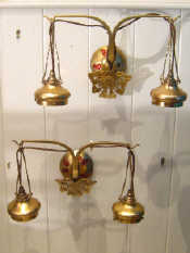 A pair of double brass wall lights in the Art