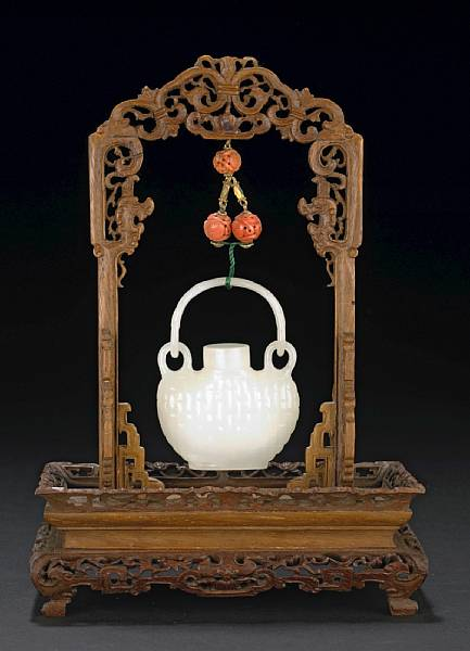 A small white jade hanging vase and cover The flattened