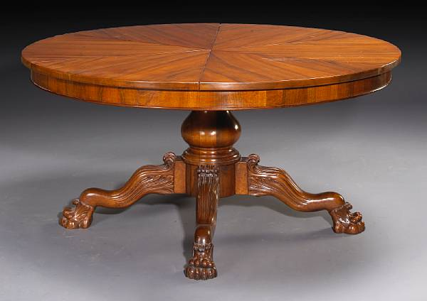 An Italian Baroque style walnut extension dining table The circular