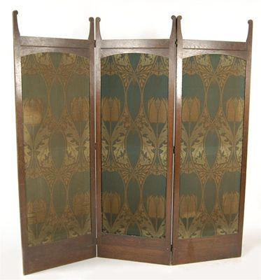 An Arts and Crafts three fold screen inset with arched