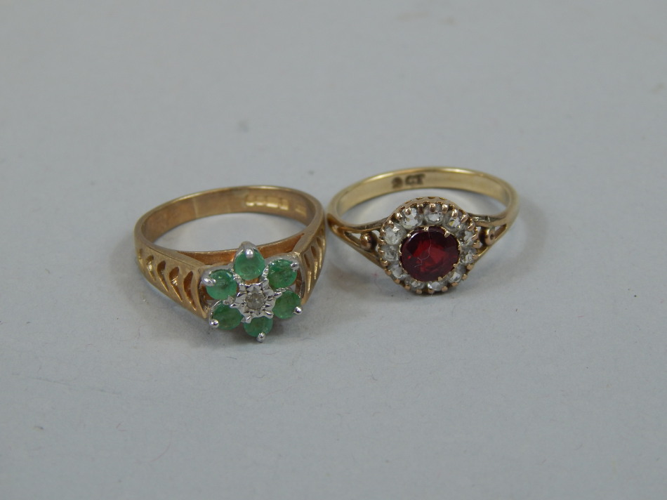 Two ladies dress rings comprising one with red stones surrounded