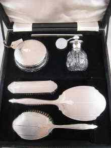 A silver dressing table set complete with powder bowl and