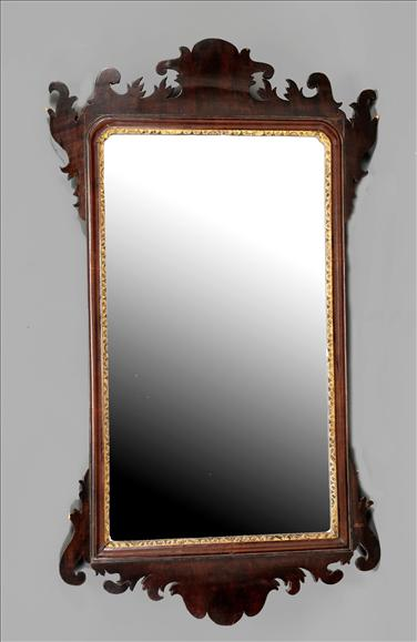 A George III mahogany and parcel gilt fretwork wall mirror