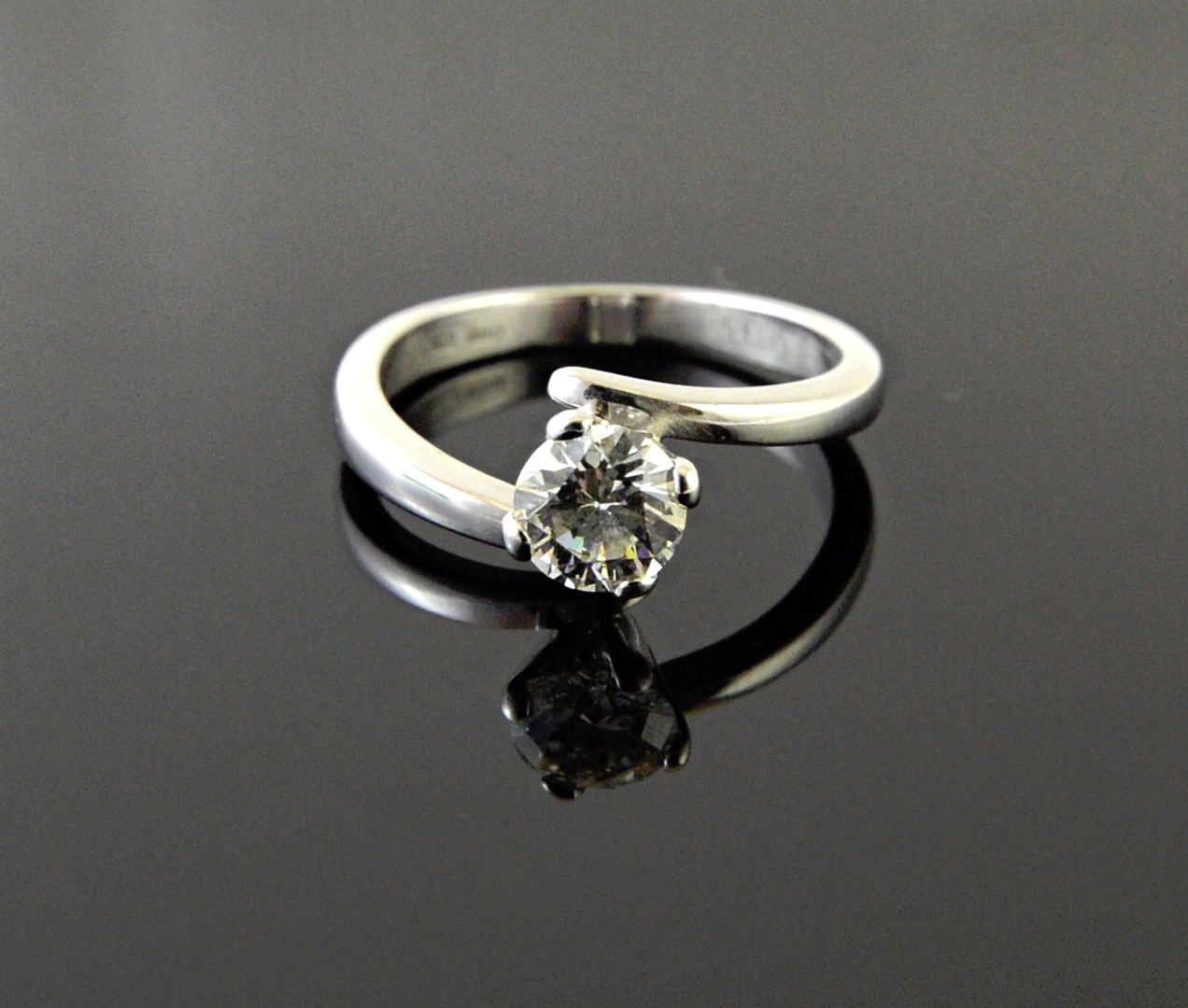 A white gold and diamond set single stone ring claw
