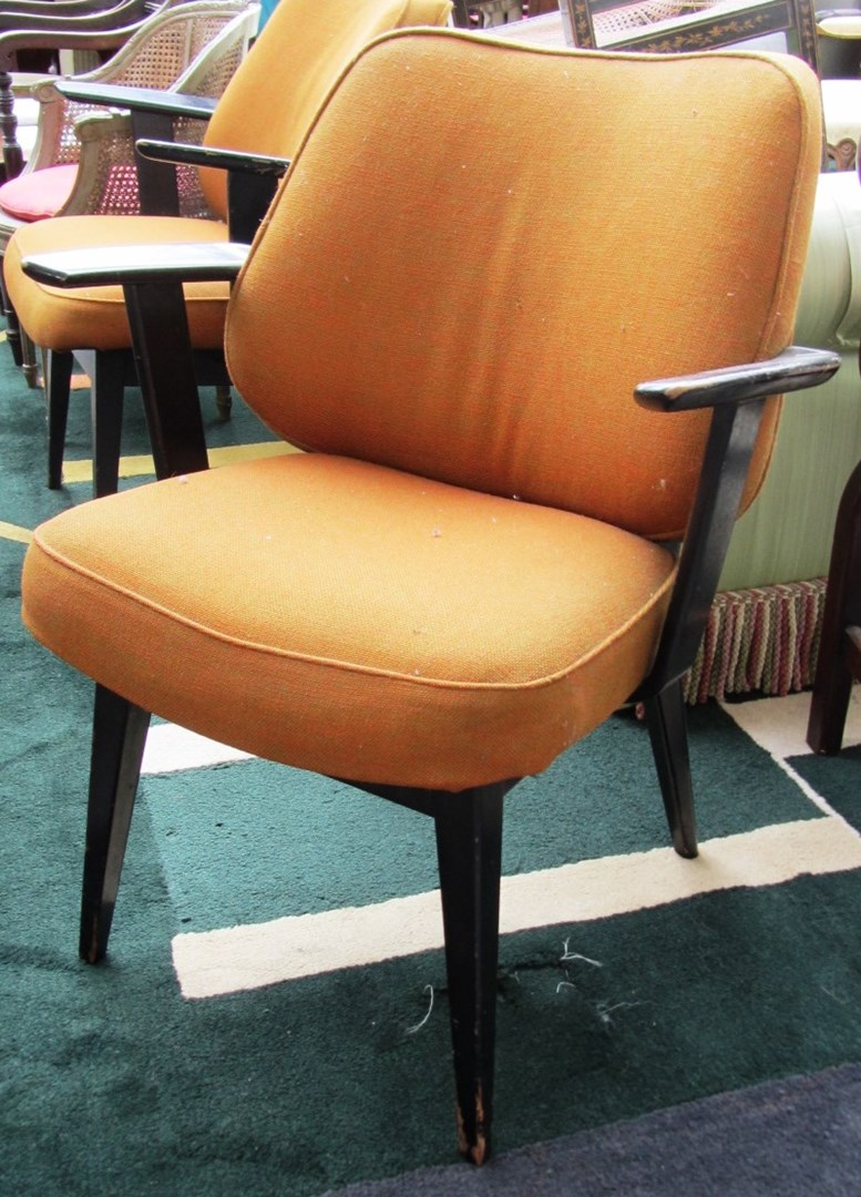 A pair of 20th century ebonised armchairs on tapering square