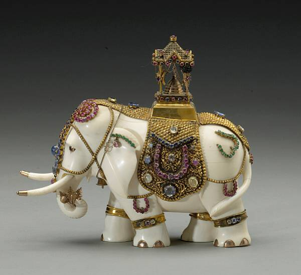 A pieced ivory elephant with gilt metal and colored stone