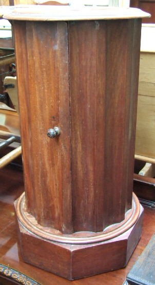 A 19th century mahogany pot cupboard with fluted column raised