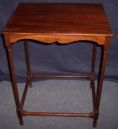 A mahogany side table the rectangular top on slender turned