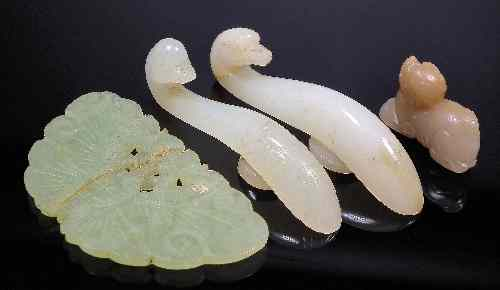Two Chinese white jade belt hooks with birds head terminal