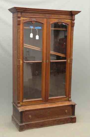Victorian walnut two door single drawer Eastlake bookcase on stand