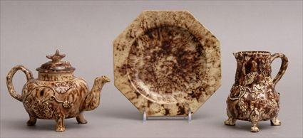 THREE STAFFORDSHIRE TORTOISESHELL GLAZED TEA ARTICLES Comprising a teapot and