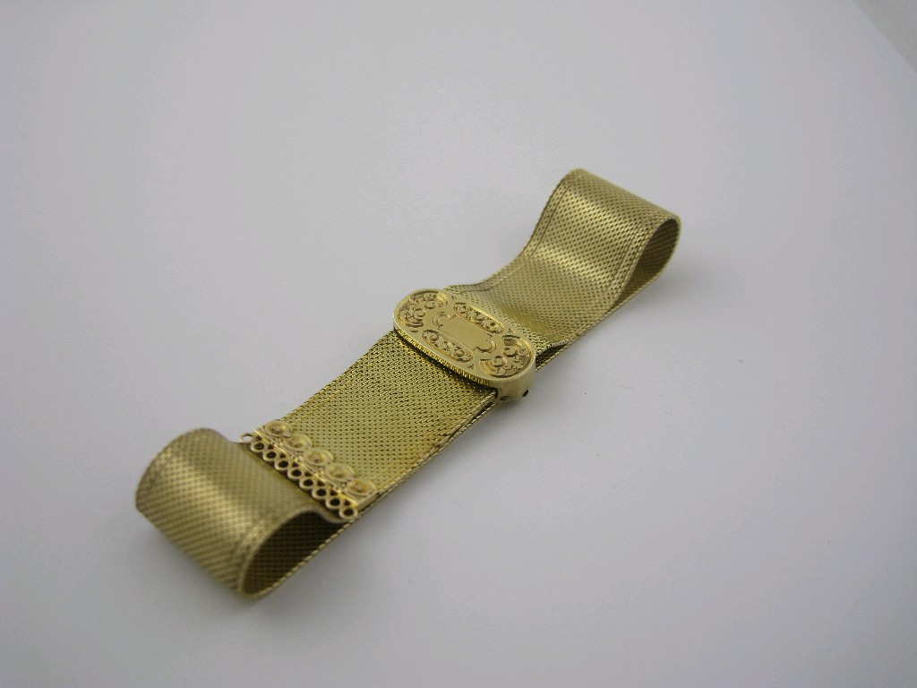 A finely woven gold Ribbon Bracelet with scroll engraved sliding