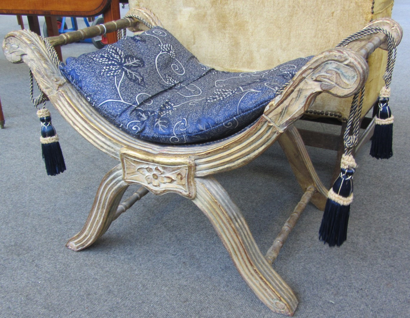 An Empire design parcel gilt X frame stool 77cm wide
