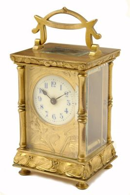 A French Art Nouveau gilt brass carriage clock with a