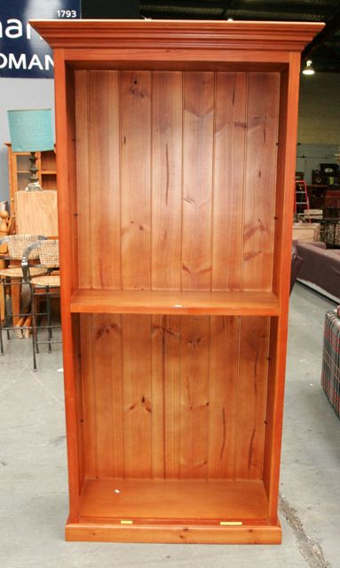 A pine bookcase 113cm wide 41cm deep 208cm tall