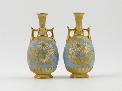 A pair of Royal Worcester vases decorated with large white