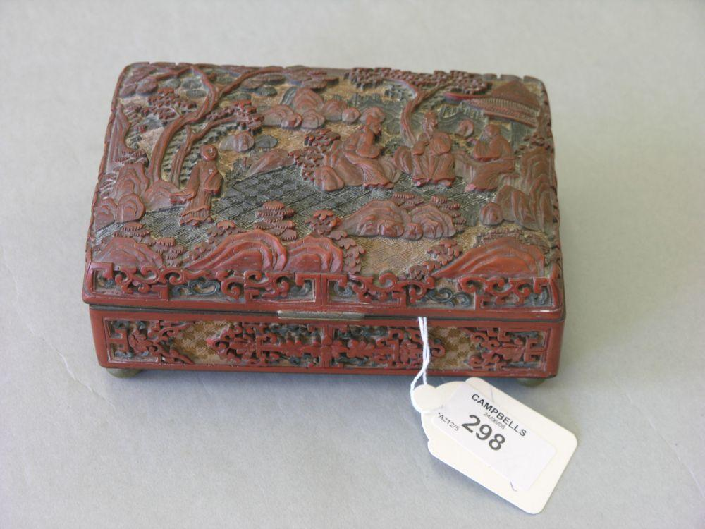 A late 19th century Chinese cinnebar lacquer casket carved with