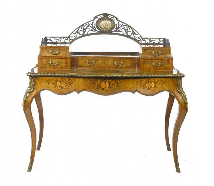 A VICTORIAN ORMOLU MOUNTED WALNUT AND MARQUETRY SERPENTINE WRITING TABLE
