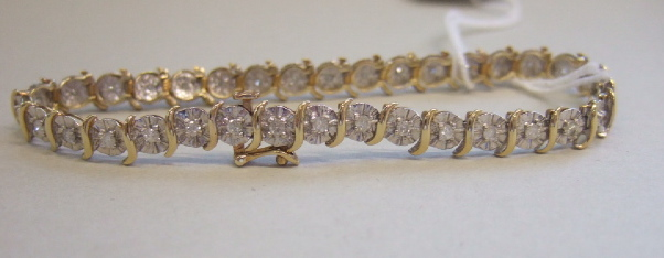 A 9ct gold and diamond set bracelet mounted with circular