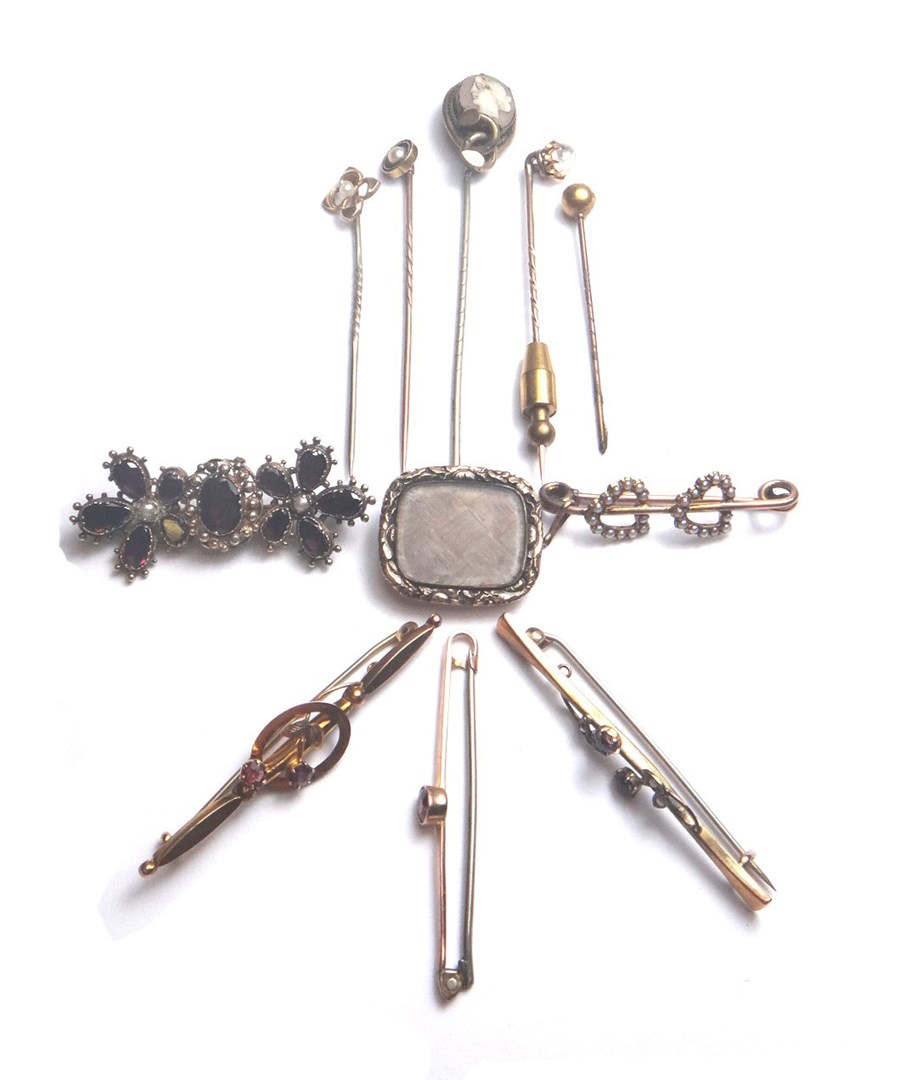 A flat cut garnet and half pearl set brooch with