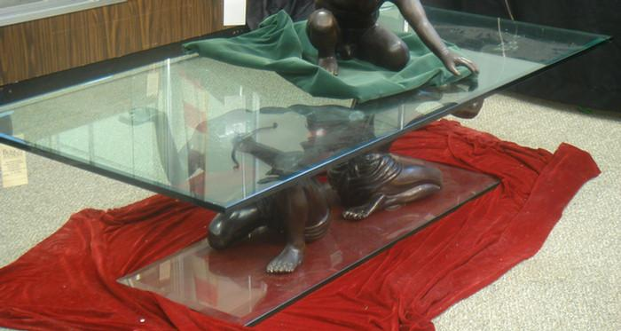 Plate glass coffee table with double crouched figure support 68