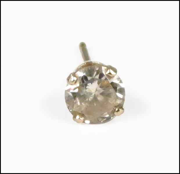 SINGLE DIAMOND STUD EARRING Set in 14 karat yellow gold