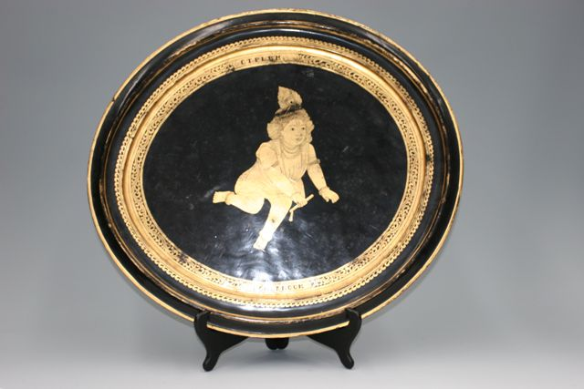 A Burmese oval platter gold on black lacquer decorative platter