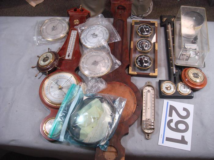 Group of aneroid barometers with an early banjo barometer case
