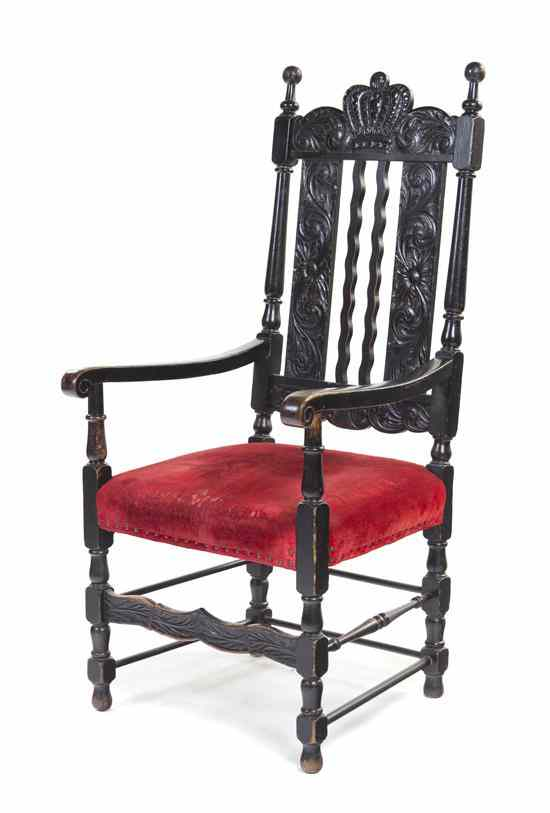 A Henry II Style Open Armchair having a carved crown