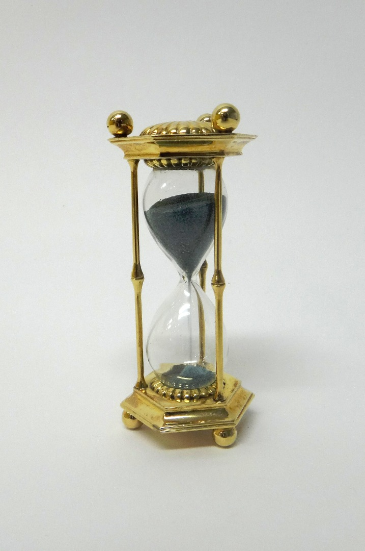 A Bvlgari gold mounted hexagonal cased sand glass with fluted