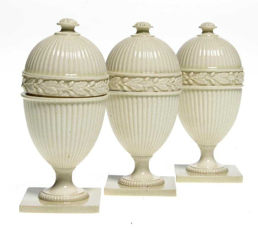 A SET OF THREE WEDGWOOD QUEEN S WARE EGG CUPS