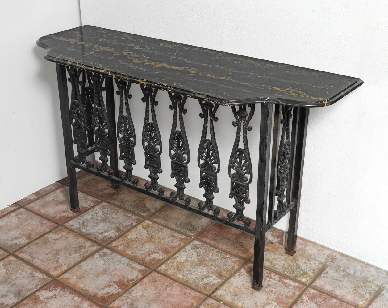 MARBLE TOP IRON TABLE Iron hall table having a surmounting