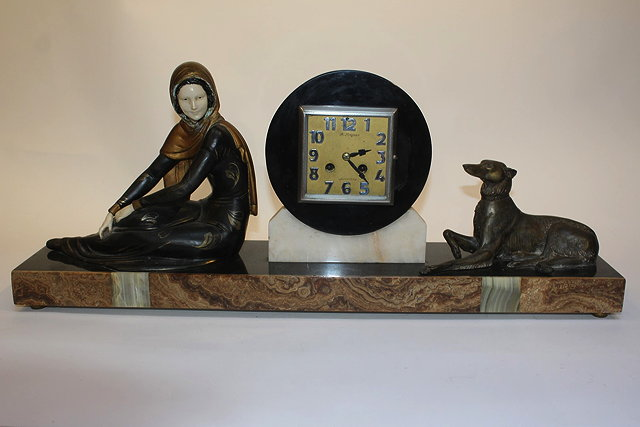 A FRENCH ART DECO SLATE MARBLE AND SPELTER MOUNTED MANTEL