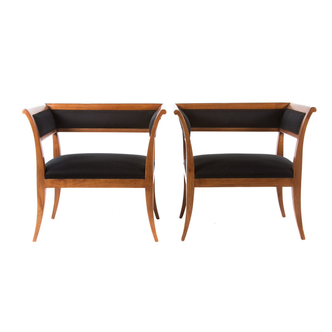 Pair of French Empire style cherrywood armchairs attributed to Guido