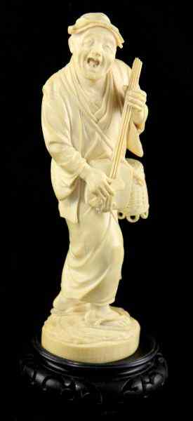 Japanese Ivory Okimonoof an old musician holding a stringed instrument