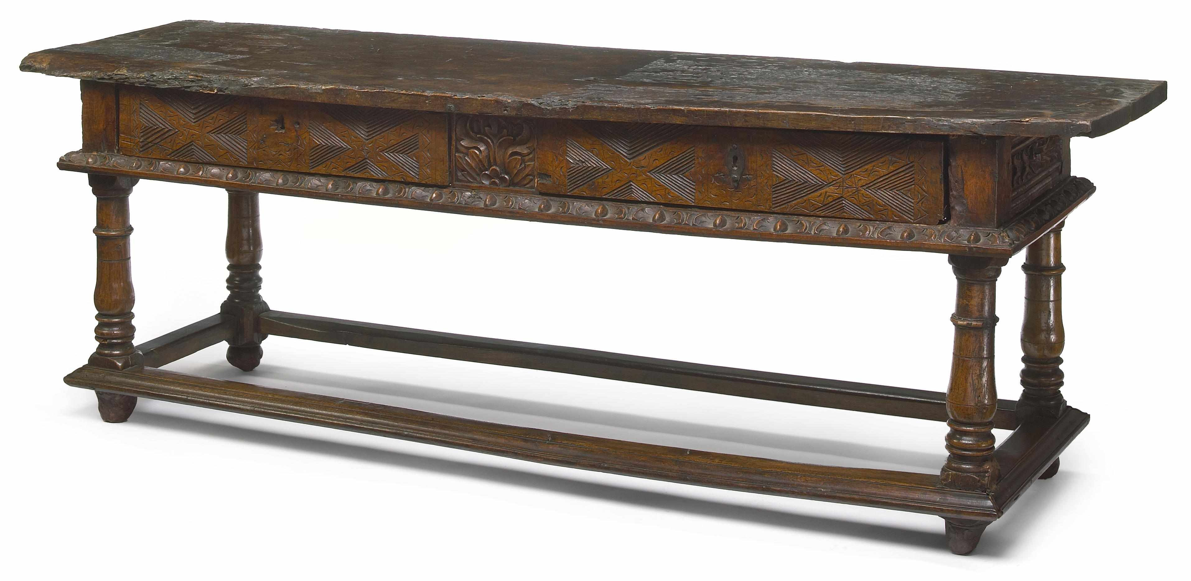 A Spanish Baroque carved walnut table incorporating antique and later