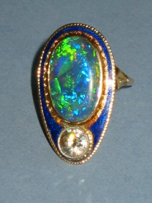 A DIAMOND AND BLACK OPAL DRESS RING comprising single brilliant