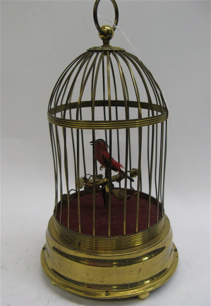 A SWISS MECHANICAL BIRD IN CAGE the a brass plated