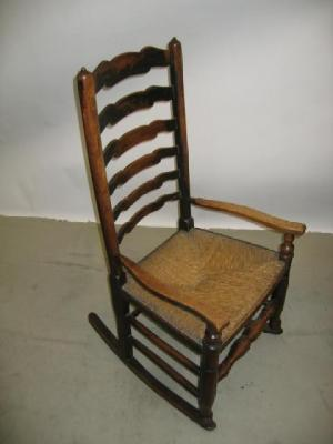 AN ASH AND ELM ROCKING CHAIR of ladder back form