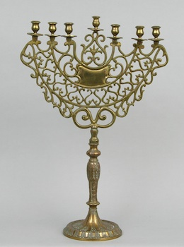 A Cast Brass Candelabra A cast brass ornately formed candelabra