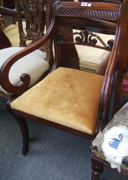 A George IV mahogany open armchair with a gadrooned top