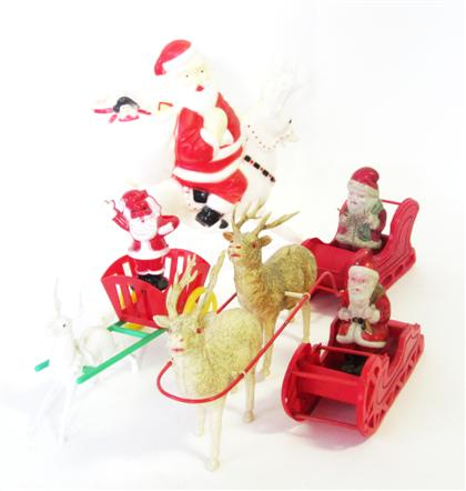 Group of celluloid and hard plastic Santa Claus and reindeer