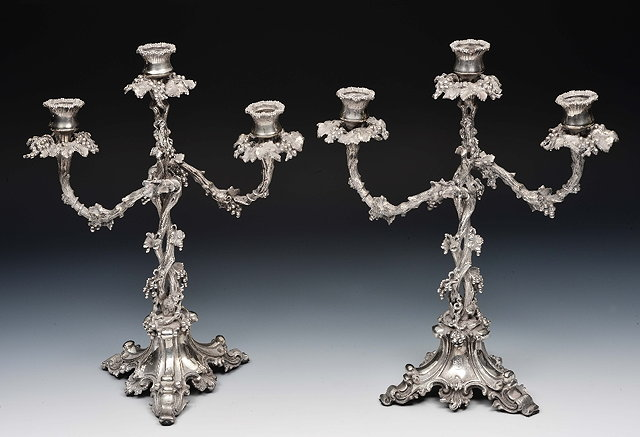 Pair of silver plated three branch candelabrawith allover vine leaf