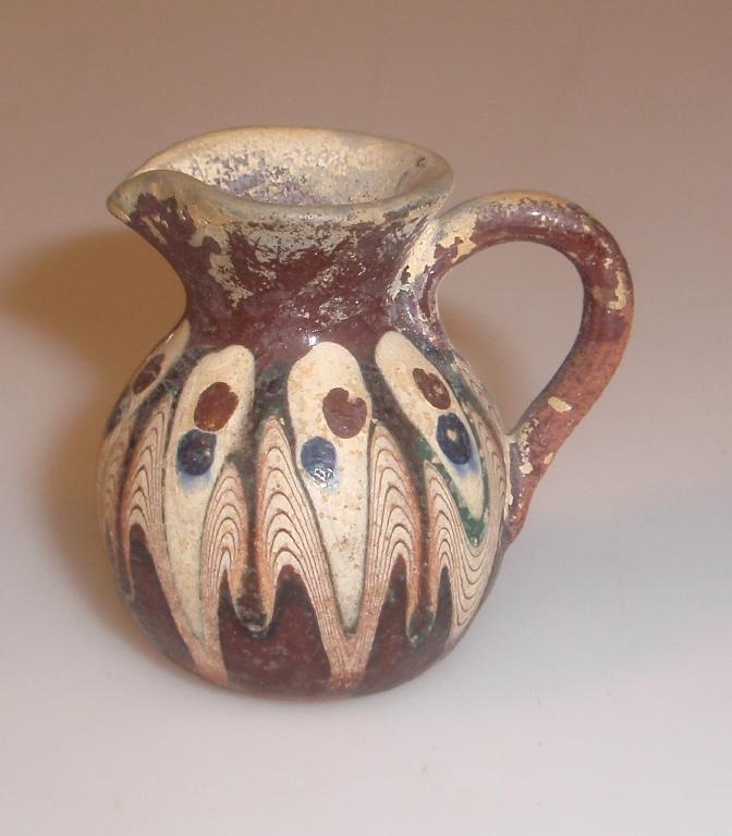 A miniature ancient pottery jug with pouring lip and pear