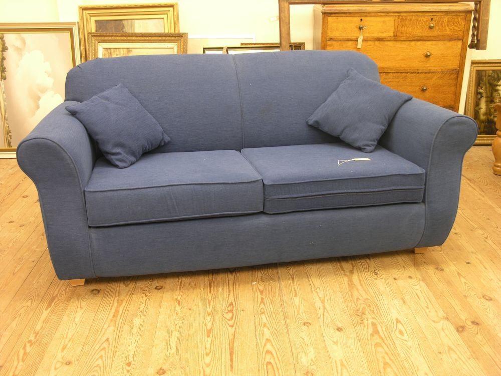 A modern two seater bed settee covered in a deep