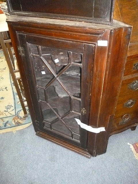 AN ANTIQUE MAHOGANY GLAZED CORNER CUPBOARD together with a caned