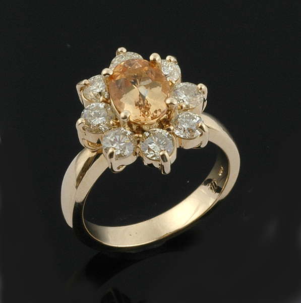 A golden topaz and diamond ring The flower cluster comprising