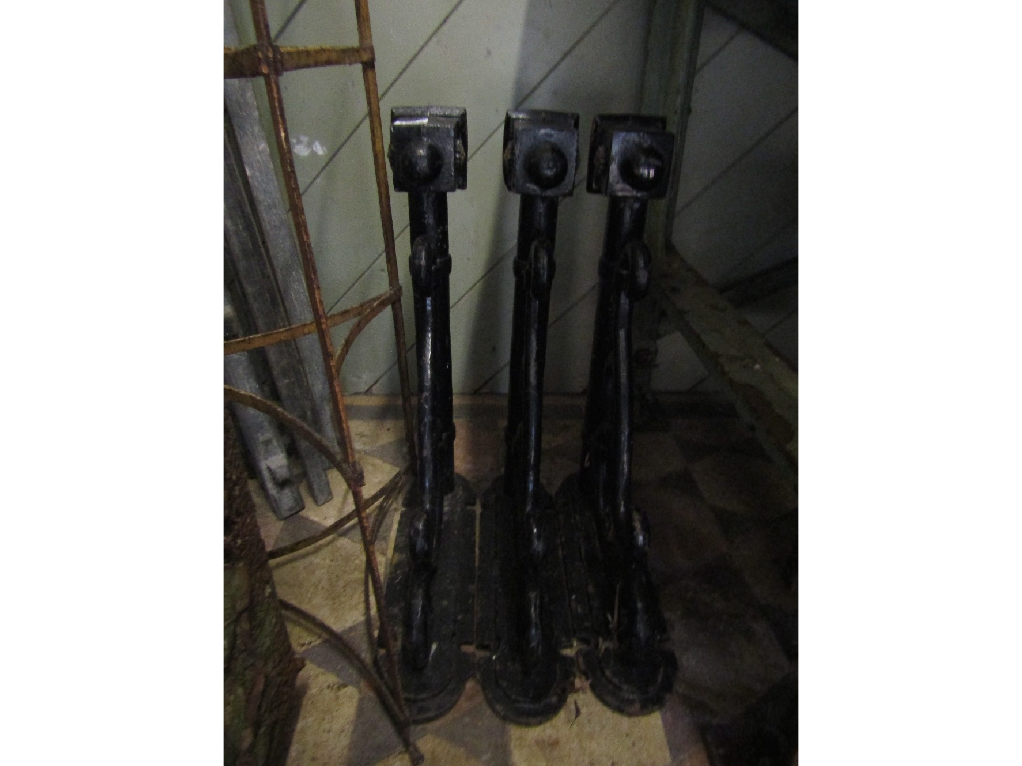 Three matching cast iron exterior wall mounted lamp brackets with