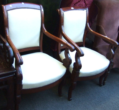 A pair of Charles X mahogany framed fauteuils each upholstered
