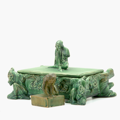 ATLANTIC Two figural pieces covered in green vellum glaze a